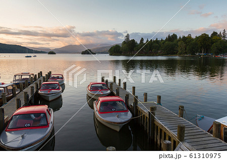 Tranquil dusk scene of Boats moored in piers in 61310975