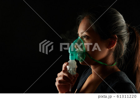 Hispanic woman with medicine mask 61311220