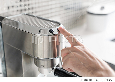 Guy prepare delicious aromatic coffee in a coffee Guy prepare delicious aromatic coffee in a coffee 61311435