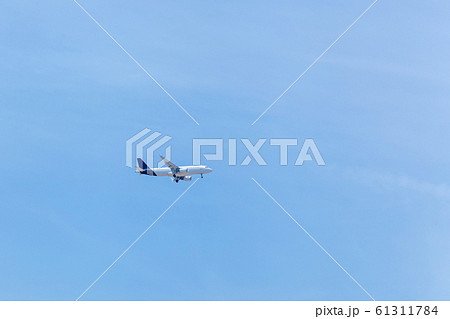 The plane is flying in the blue sky 61311784