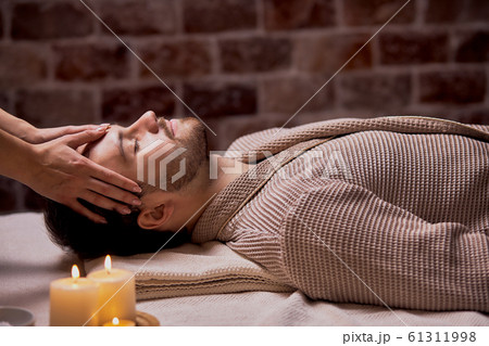 Relaxing caucasian male enjoying wellbeing wellness spa therapy 61311998