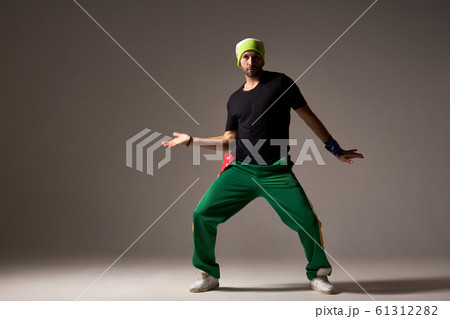 Cool looking dancing hiphopper in sportswear. 61312282