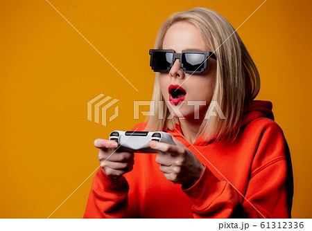 girl in sunglasses keen plays with a joystick 61312336