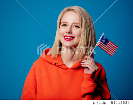 girl holds United States of America flag on blue background 61312680
