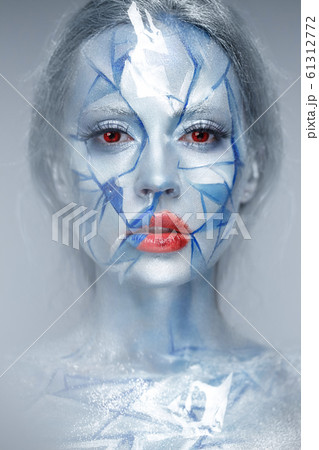 Beautiful girl in an unusual winter look with red lips. Creative make- up. Art look. Beautiful girl in an unusual winter look with red lips. Creative make- up. Art look. 61312772