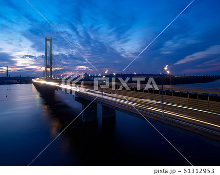 Traffic on a bridge. Modern metropolis with intersection of the traffic trails on a bridge. Traffic jams of roadside, transportation motion in a big city. Traffic on a bridge. Modern metropolis with intersection of the traffic trails on a bridge. Traffic jams of roadside, transportation motion in a big city. 61312953