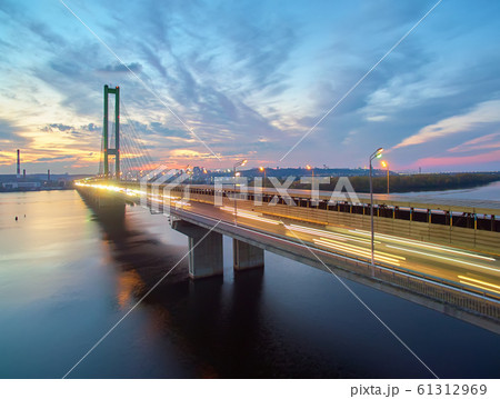Traffic on a bridge. Modern metropolis with intersection of the traffic trails on a bridge. Traffic jams of roadside, transportation motion in a big city. Traffic on a bridge. Modern metropolis with intersection of the traffic trails on a bridge. Traffic jams of roadside, transportation motion in a big city. 61312969