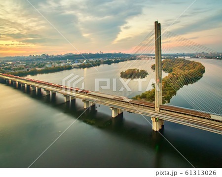 Traffic on a bridge. Modern metropolis with intersection of the traffic trails on a bridge. Traffic jams of roadside, transportation motion in a big city. 61313026