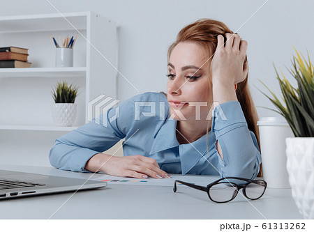 Many paper boxes in a small shopping cart on a laptop keyboard. Concepts about online shopping that consumers can buy things directly from their home or office just using a few clicks via web browser. 61313262