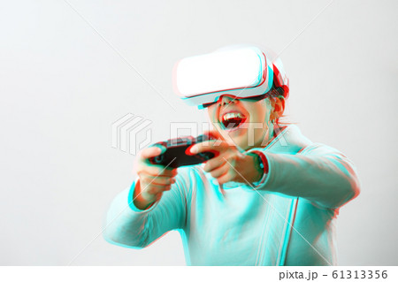 Woman with virtual reality headset is playing game. Image with glitch effect. 61313356