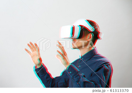 Man with virtual reality headset is playing game. Image with glitch effect. 61313370