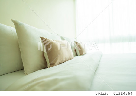 White comfortable pillow on bed decoration interior White comfortable pillow on bed decoration interior 61314564