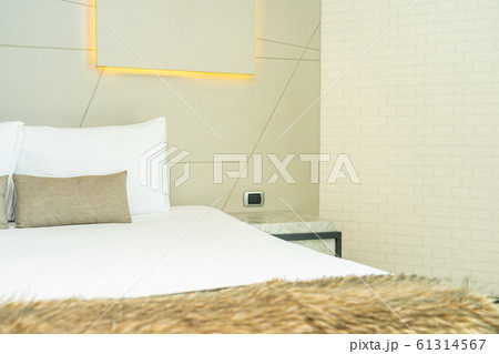 White comfortable pillow on bed decoration interior White comfortable pillow on bed decoration interior 61314567