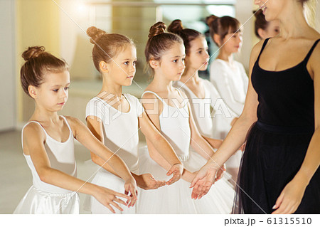 young professional female ballerina teaching girls to dance young professional female ballerina teaching girls to dance 61315510