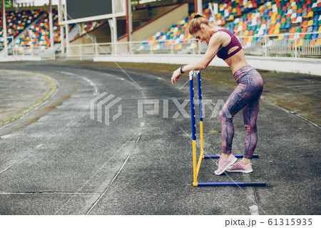 The girl at the stadium is playing sports The girl at the stadium is playing sports 61315935