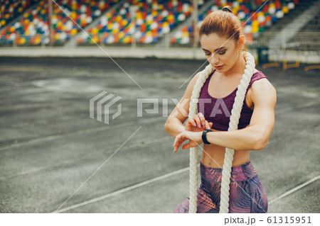 The girl at the stadium is playing sports 61315951