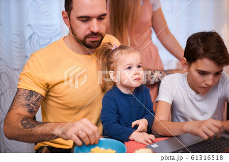 awesome caucasian family with laptop in kitchen at home 61316518