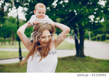 Mom and son relax in the park. 61316992