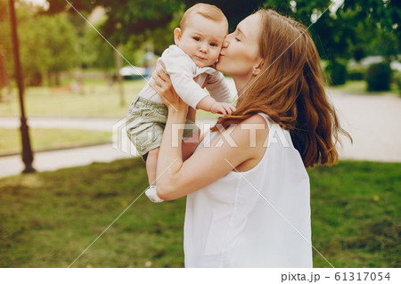 Mom and son relax in the park. 61317054