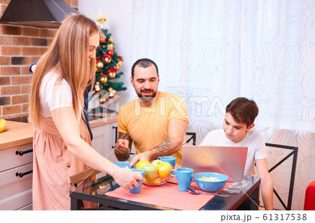 caucasian family sit in kitchen together 61317538