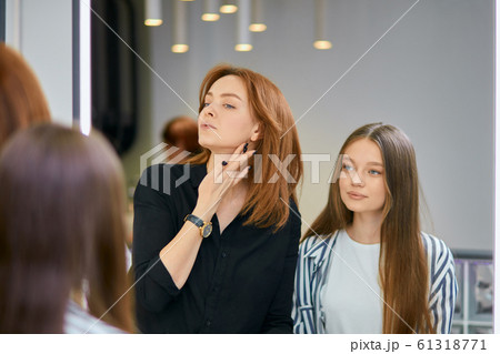 make-up artist with client in beauty saloon make-up artist with client in beauty saloon 61318771