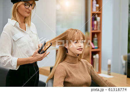 professional hairdresser doing her daily work 61318774