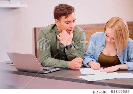 man and woman making notes, going to buy new house man and woman making notes, going to buy new house 61319687