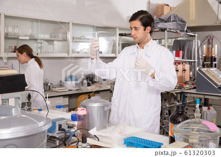 Young male chemist working in laboratory 61320303