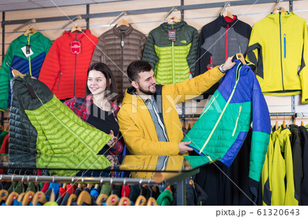 Young smiling couple choosing on windcheater 61320643