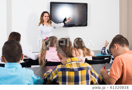 children with teacher in classroom 61320838