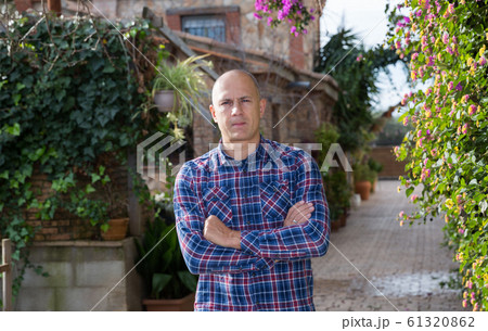 Farmer in courtyard of farmhouse 61320862