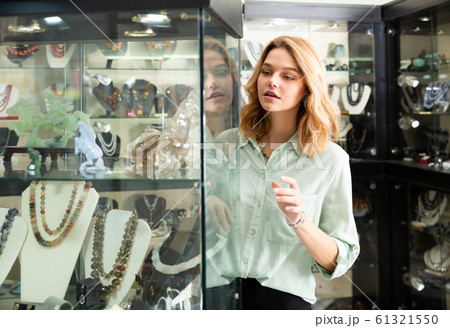 Woman looking at showcase with jewelry Woman looking at showcase with jewelry 61321550