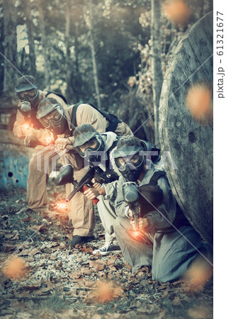Paintball players shooting with guns Paintball players shooting with guns 61321677