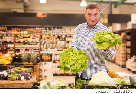 Customer buying cabbage at supermarket 61322159