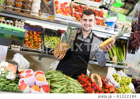 shopping assistant demonstrating assortment of grocery shop shopping assistant demonstrating assortment of grocery shop 61322184