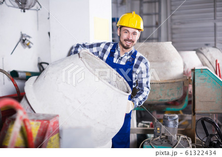 Worker work with cement mixer 61322434