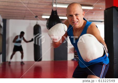 Potrait of man boxer who is training in gym Potrait of man boxer who is training in gym 61322549