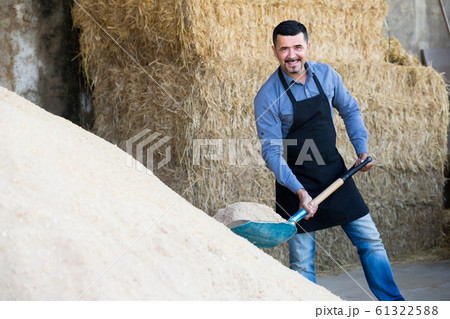 Smiling man standing with metallic spade 61322588