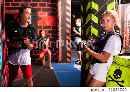 Teen kids during lasertag game Teen kids during lasertag game 61322792