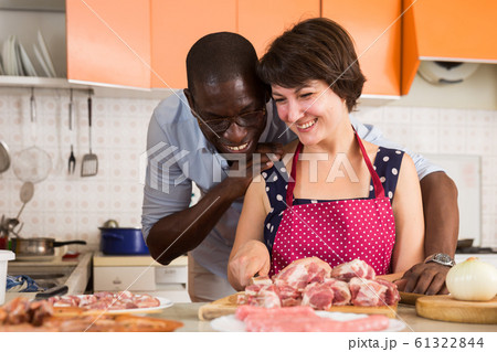 Couple making meat dinner 61322844