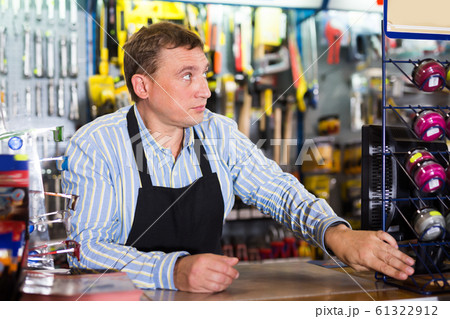 Attentive seller man in store is trading tools Attentive seller man in store is trading tools 61322912