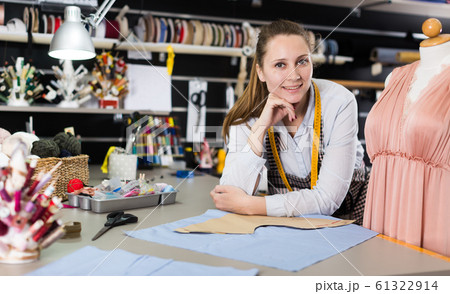 Portrait of woman seamstress who is standing on her workplace Portrait of woman seamstress who is standing on her workplace 61322914