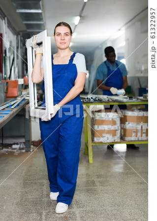 Female master is working with window frame Female master is working with window frame 61322957