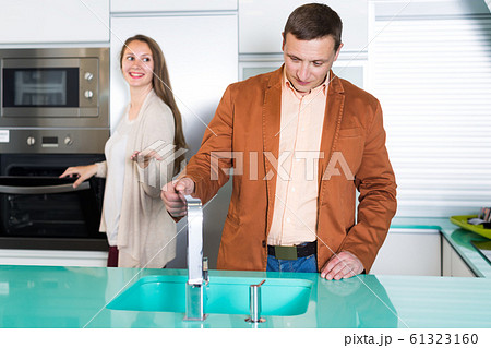Positive couple customers choosing tabletop Positive couple customers choosing tabletop 61323160