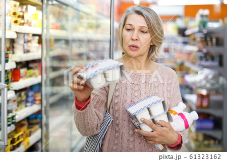 Amazed adult woman reading contents of goods 61323162