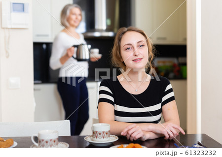 Woman at kitchen table Woman at kitchen table 61323232