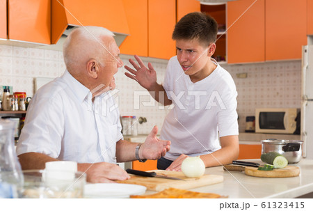 Teenage boy friendly talking to grandfather 61323415