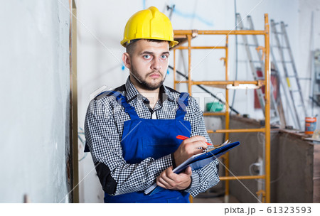 Professional builder is signing documents about the report 61323593