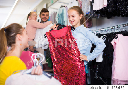 Daughter with adult mother choosing gala dress 61323682