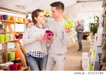 Couple choosing flowerpots Couple choosing flowerpots 61323788